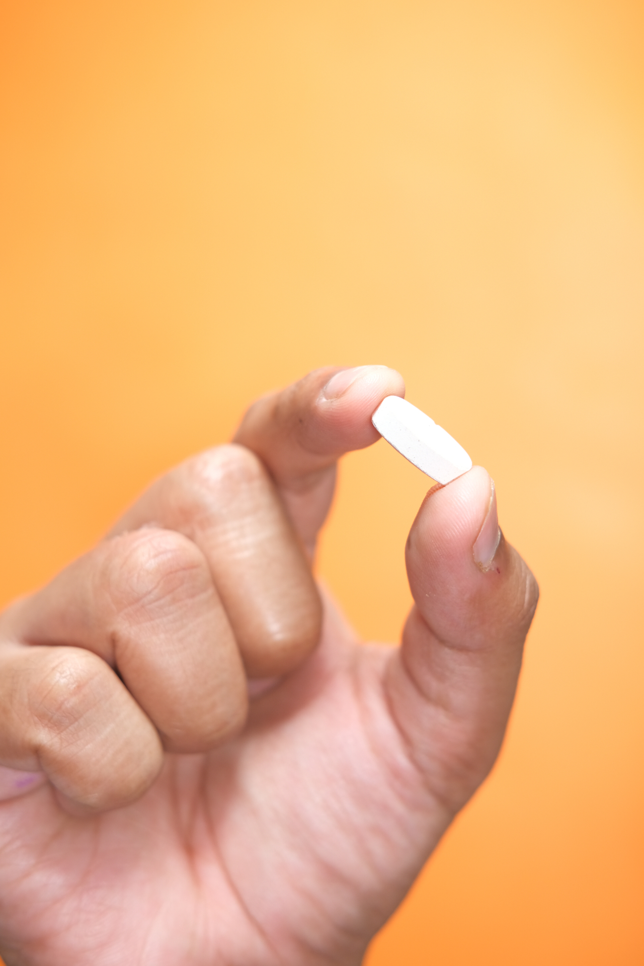 Hand holding a Kyzatrex oral testosterone capsule
