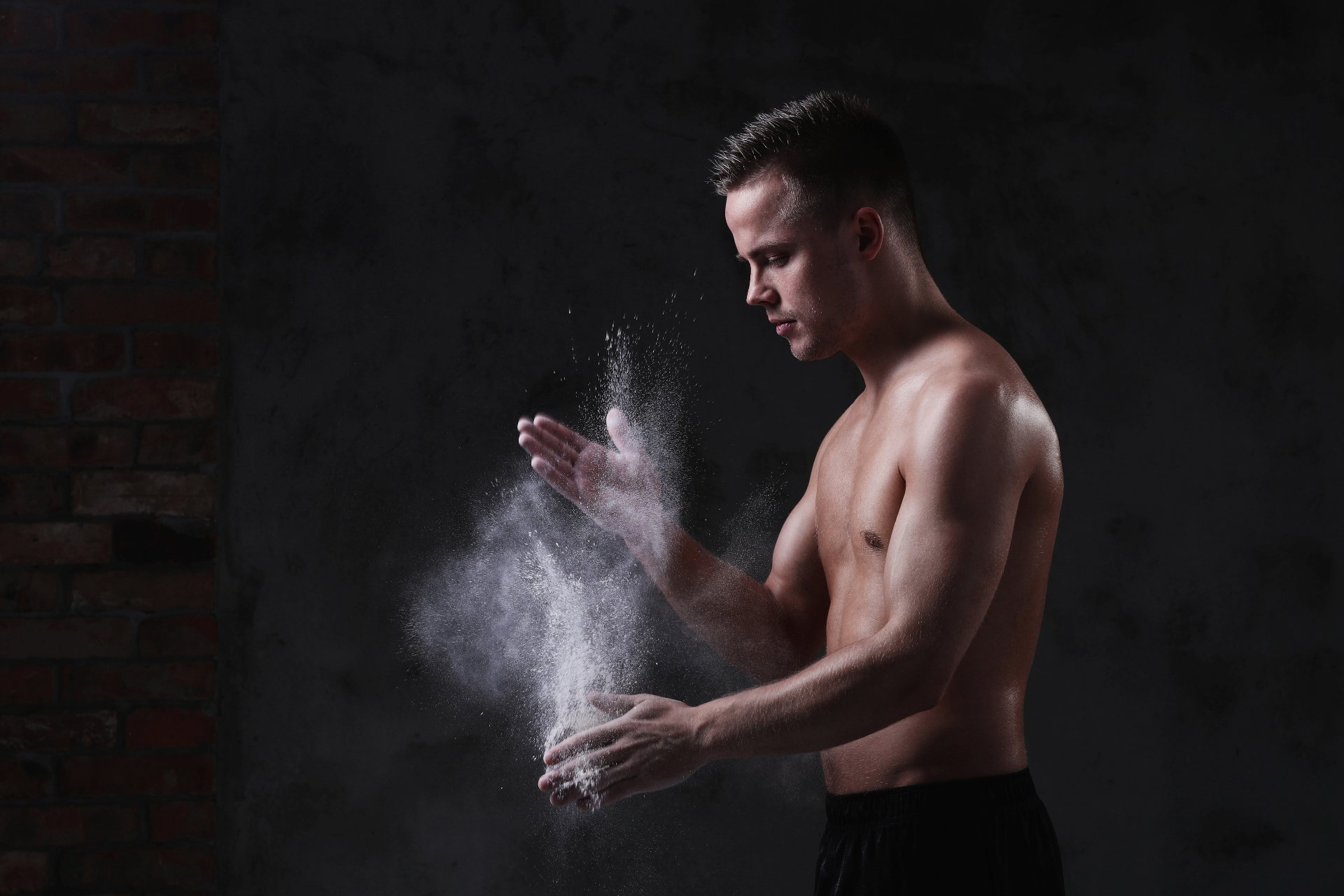 Man training in a low-lit studio