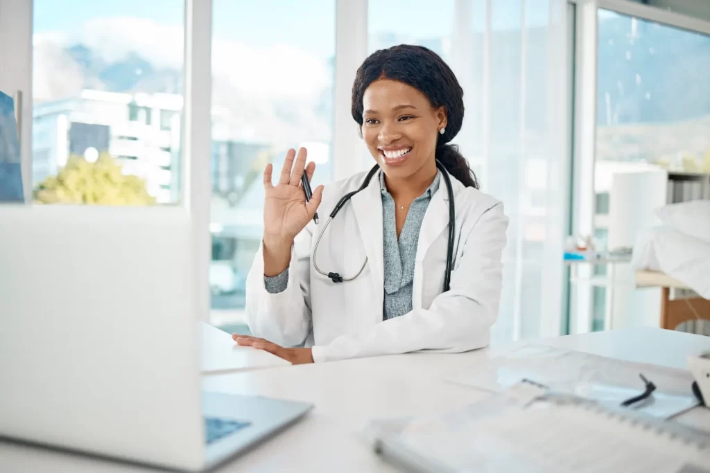 smiling-woman-doctor-waving-during-online-consulta-2026-01-09-09-53-21-utc